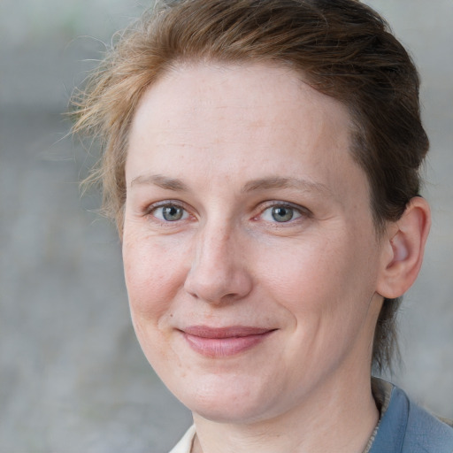 Joyful white adult female with short  brown hair and grey eyes