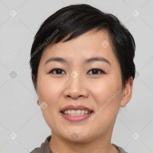 Joyful asian young-adult female with short  black hair and brown eyes