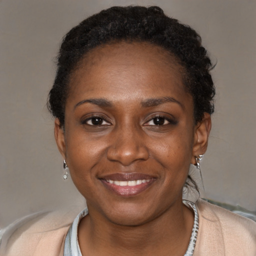 Joyful black young-adult female with short  black hair and brown eyes