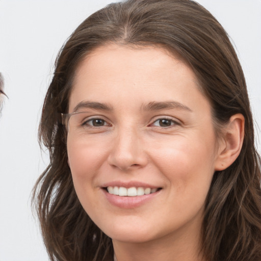 Joyful white young-adult female with long  brown hair and grey eyes