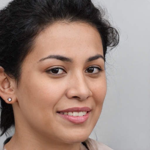 Joyful latino young-adult female with medium  brown hair and brown eyes