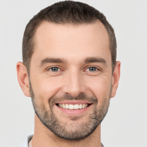 Joyful white young-adult male with short  brown hair and brown eyes