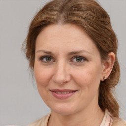 Joyful white adult female with medium  brown hair and brown eyes