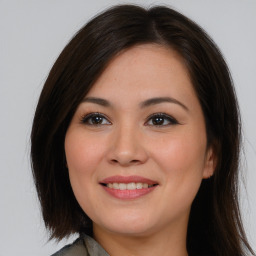 Joyful asian young-adult female with long  brown hair and brown eyes