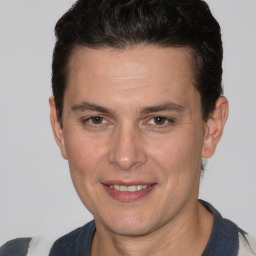 Joyful white adult male with short  brown hair and brown eyes