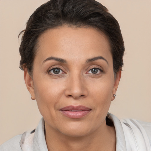 Joyful white adult female with short  brown hair and brown eyes