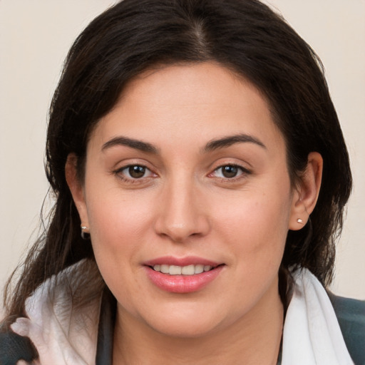 Joyful white young-adult female with medium  brown hair and brown eyes