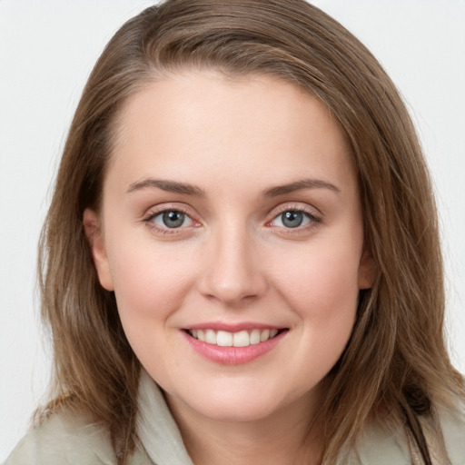 Joyful white young-adult female with medium  brown hair and grey eyes