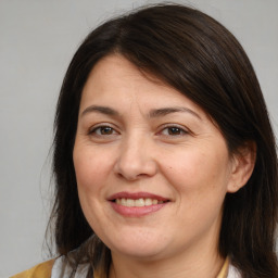 Joyful white adult female with medium  brown hair and brown eyes