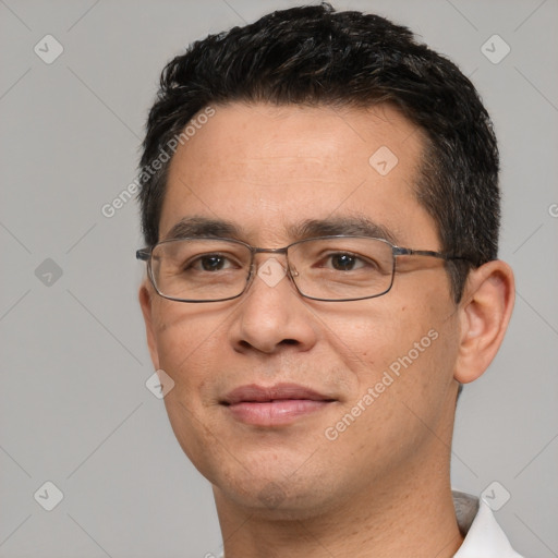 Joyful white adult male with short  black hair and brown eyes