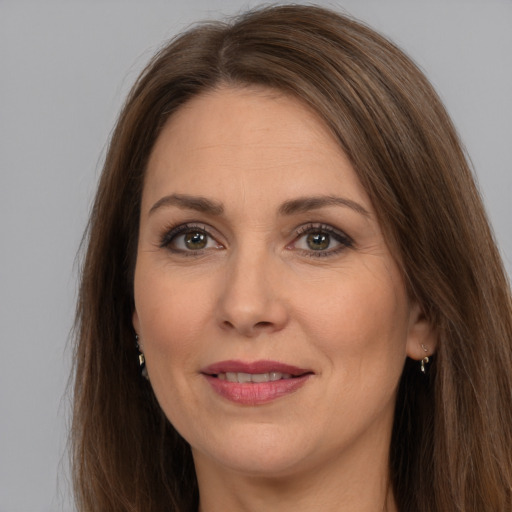 Joyful white adult female with long  brown hair and brown eyes