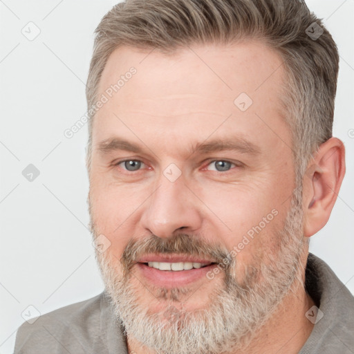 Joyful white adult male with short  brown hair and grey eyes