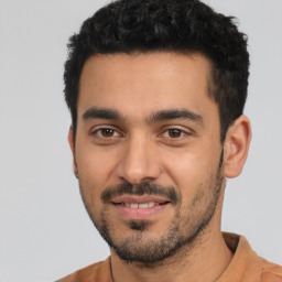 Joyful latino young-adult male with short  black hair and brown eyes