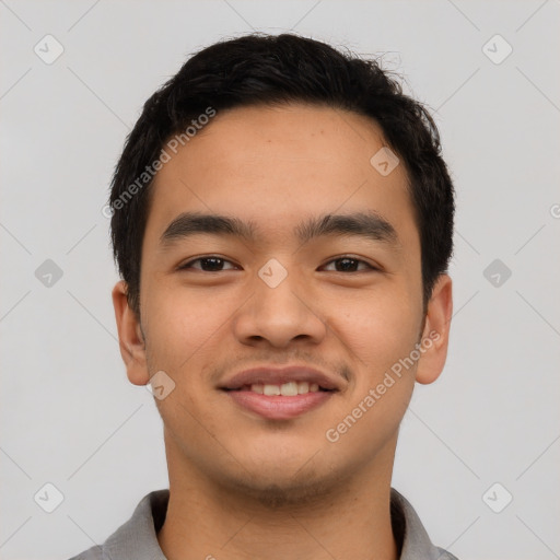 Joyful asian young-adult male with short  black hair and brown eyes