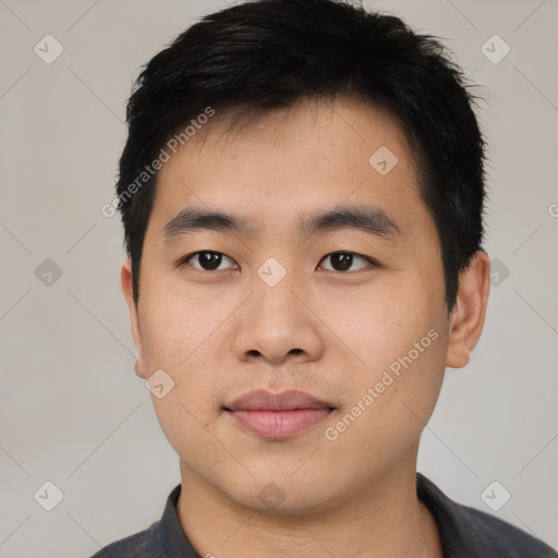 Joyful asian young-adult male with short  black hair and brown eyes