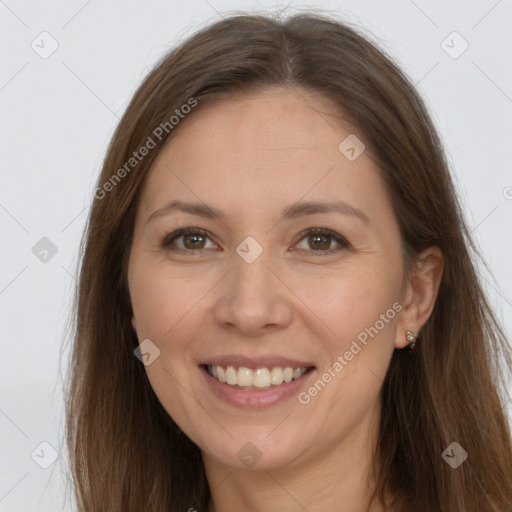 Joyful white adult female with long  brown hair and grey eyes