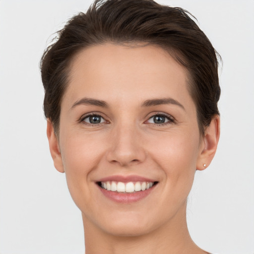 Joyful white young-adult female with short  brown hair and brown eyes