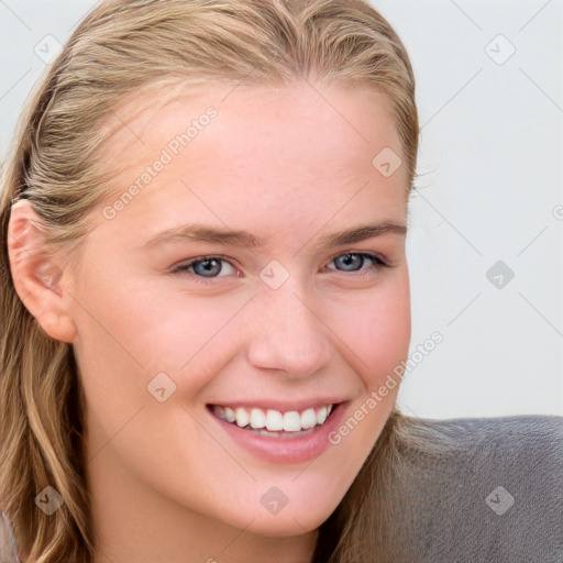 Joyful white young-adult female with long  brown hair and blue eyes