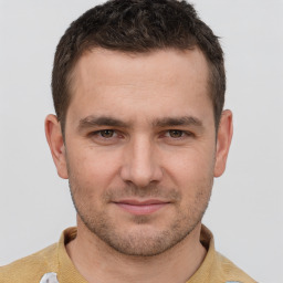 Joyful white young-adult male with short  brown hair and brown eyes