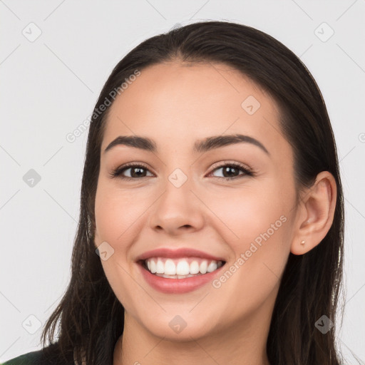 Joyful white young-adult female with long  brown hair and brown eyes