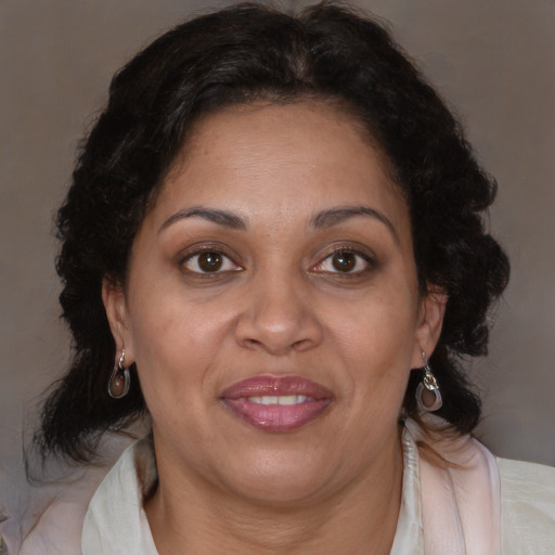 Joyful latino adult female with medium  brown hair and brown eyes