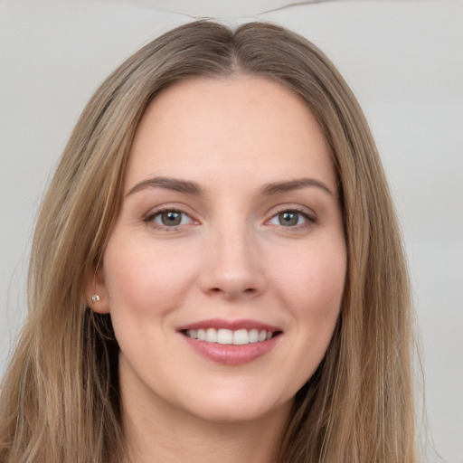 Joyful white young-adult female with long  brown hair and grey eyes