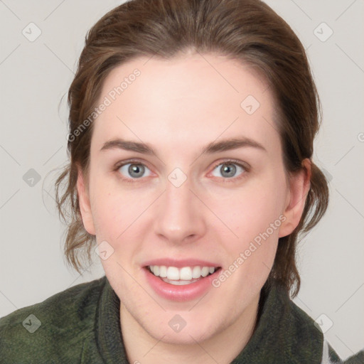 Joyful white young-adult female with medium  brown hair and green eyes