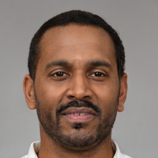 Neutral latino adult male with short  brown hair and brown eyes