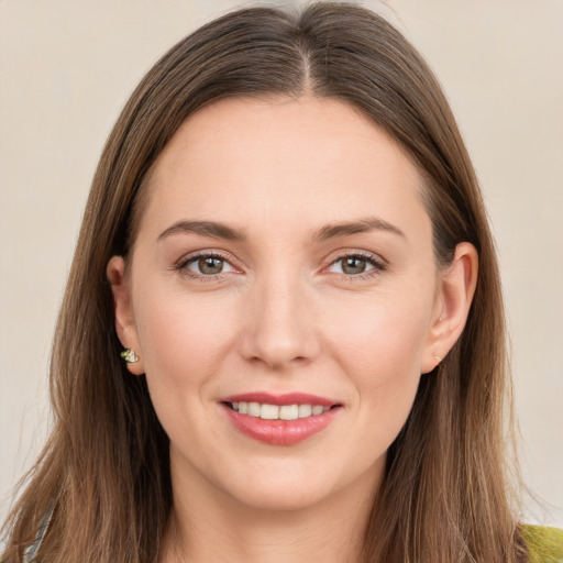 Joyful white young-adult female with long  brown hair and brown eyes