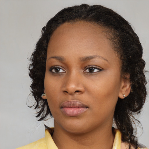 Neutral black young-adult female with medium  brown hair and brown eyes
