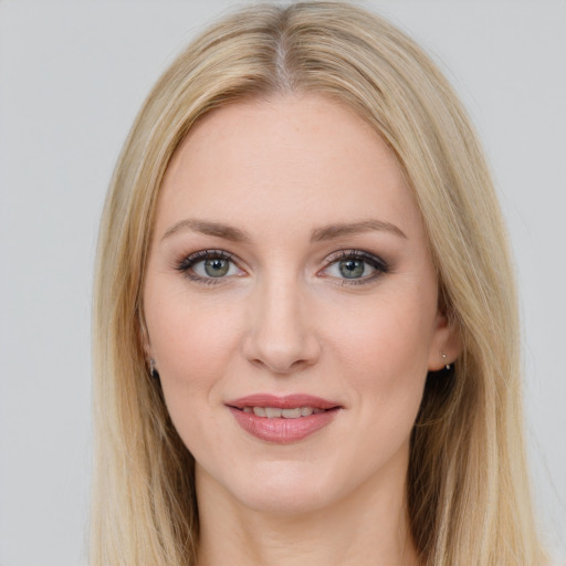 Joyful white young-adult female with long  brown hair and blue eyes