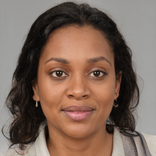 Joyful black young-adult female with medium  brown hair and brown eyes