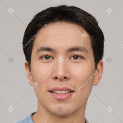 Joyful asian young-adult male with short  brown hair and brown eyes