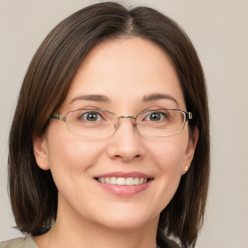 Joyful white adult female with medium  brown hair and grey eyes