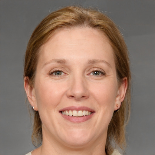 Joyful white adult female with medium  brown hair and blue eyes