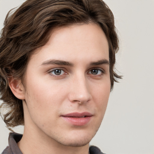 Joyful white young-adult male with medium  brown hair and brown eyes