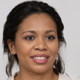 Joyful latino young-adult female with medium  brown hair and brown eyes