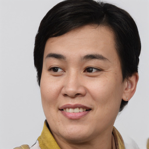 Joyful asian young-adult male with medium  brown hair and brown eyes