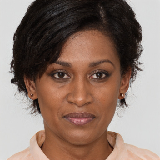 Joyful black adult female with medium  brown hair and brown eyes