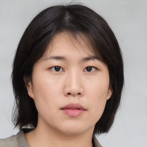 Neutral asian young-adult female with medium  brown hair and brown eyes