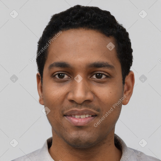 Joyful black young-adult male with short  black hair and brown eyes