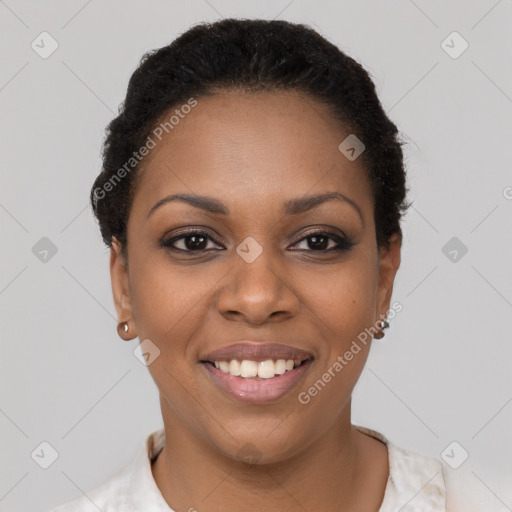 Joyful black young-adult female with short  black hair and brown eyes