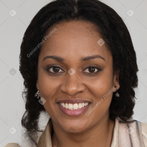 Joyful black young-adult female with long  brown hair and brown eyes