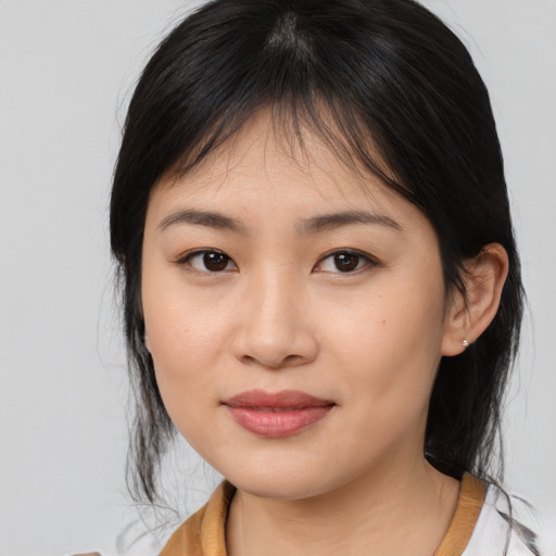 Joyful asian young-adult female with medium  brown hair and brown eyes