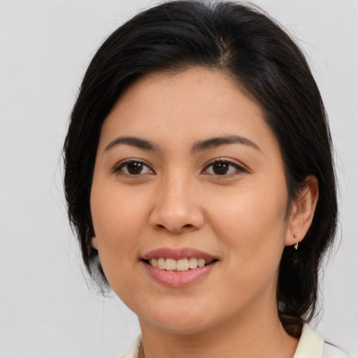 Joyful asian young-adult female with medium  brown hair and brown eyes