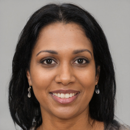 Joyful black young-adult female with medium  brown hair and brown eyes