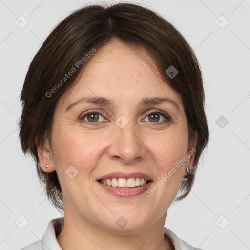 Joyful white adult female with medium  brown hair and grey eyes