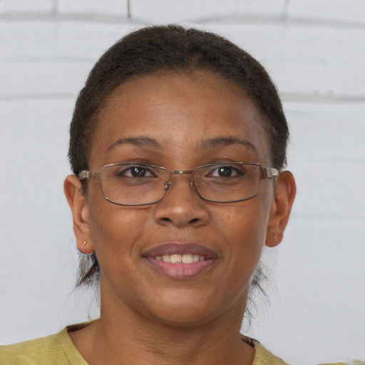 Joyful black adult female with short  brown hair and brown eyes