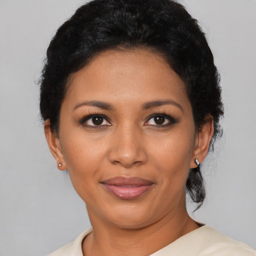 Joyful latino young-adult female with short  black hair and brown eyes