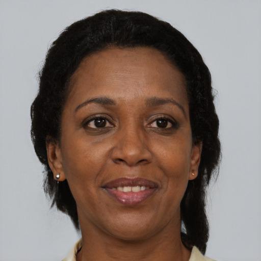 Joyful black adult female with short  brown hair and brown eyes